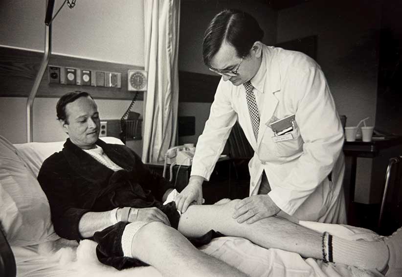 Chief Dr. Roy Wert with a patient in the early 1980s.
