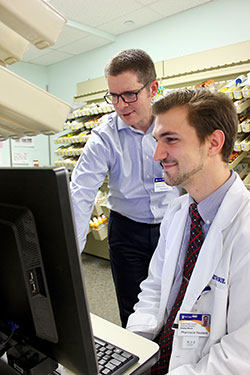 Pharmacists looking at computer 