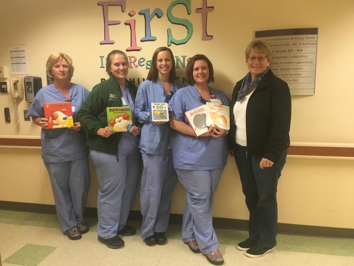 Nurses holding baby books