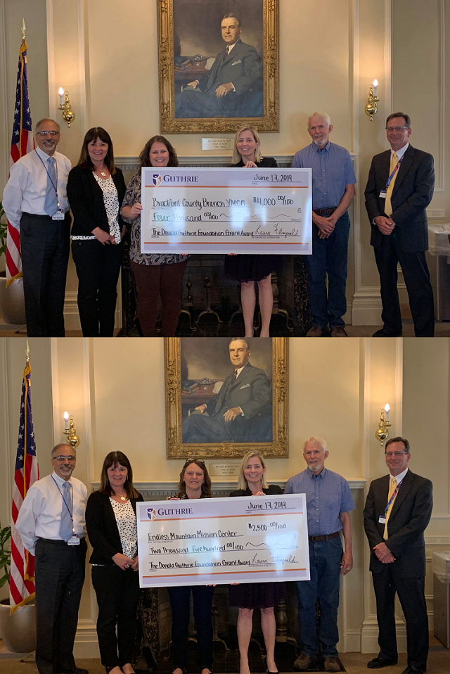 people standing with large check 