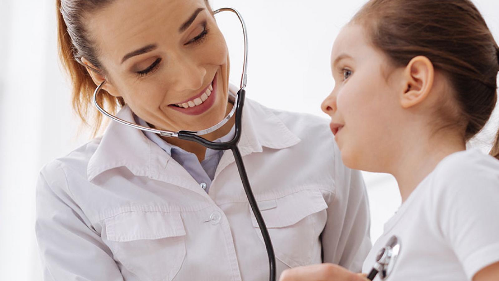 Doctor using stethoscope on child 