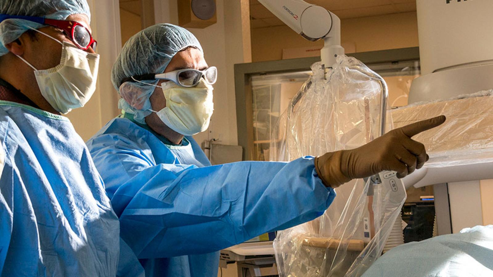 Surgeons looking at computer screen 