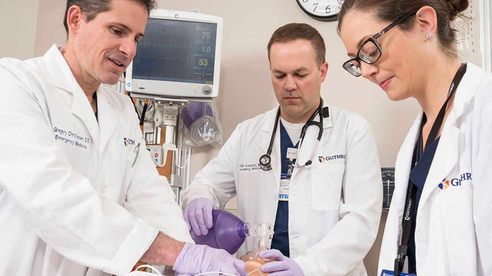 doctors practicing on model patient 