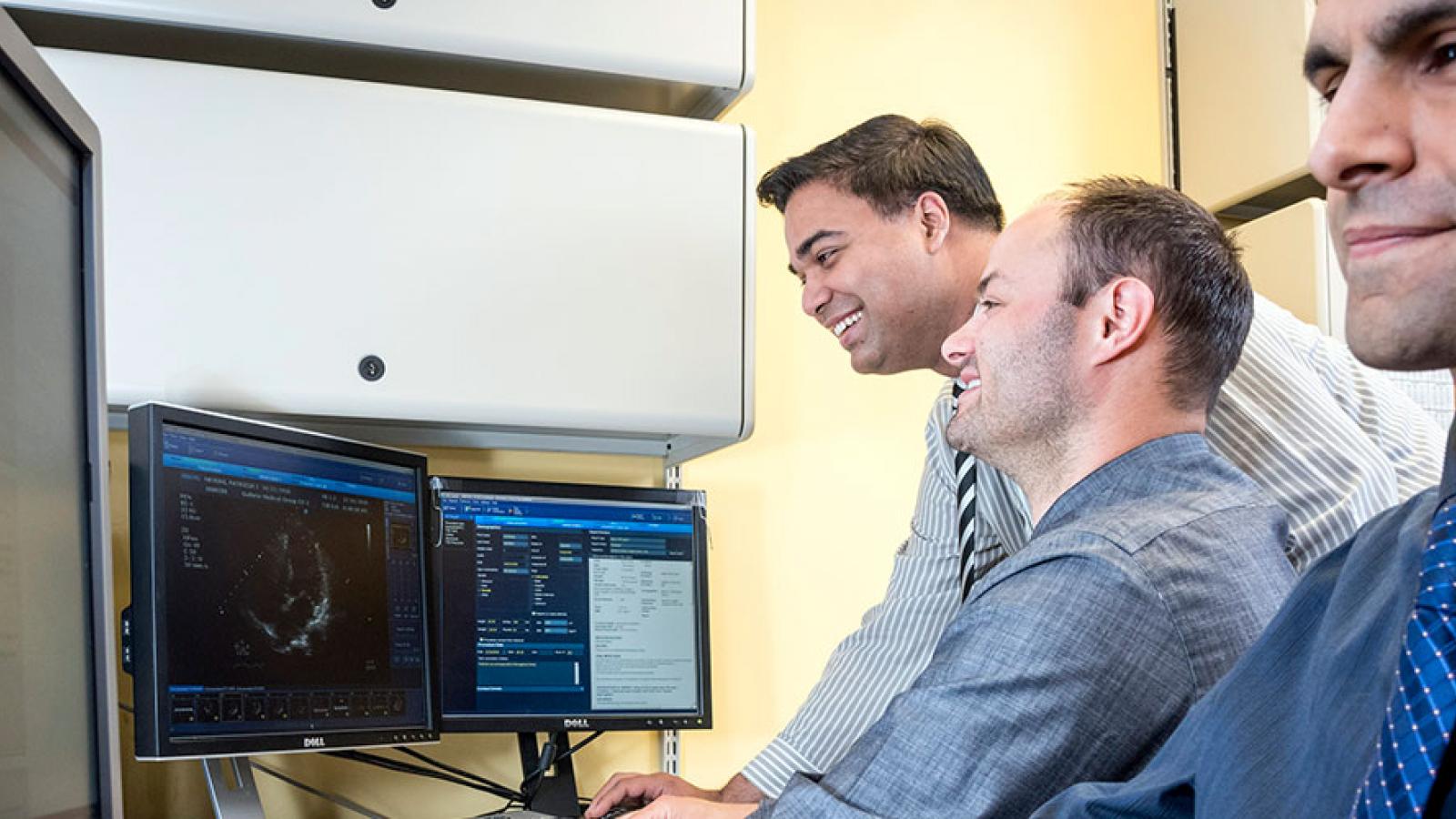 doctors looking at computers 