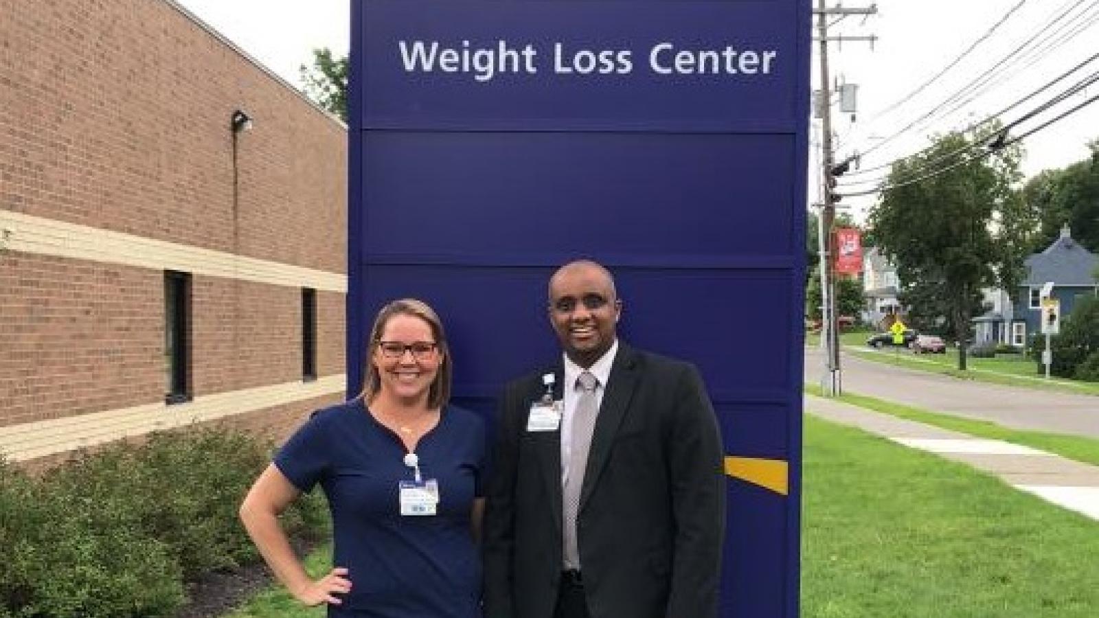 Providers standing in front of sign