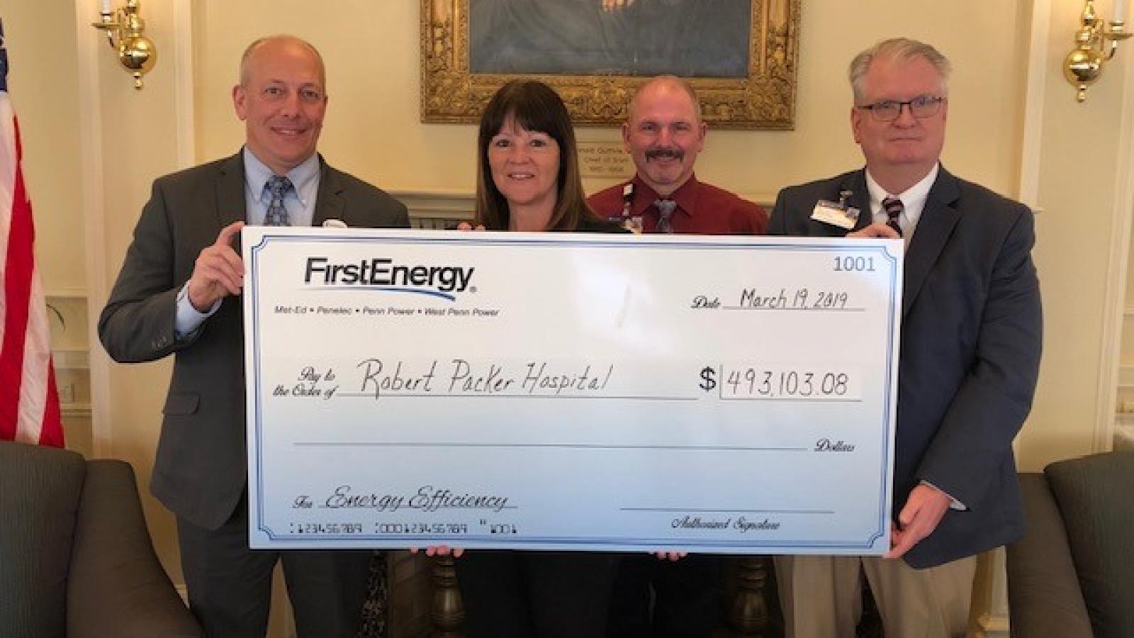 People holding large check