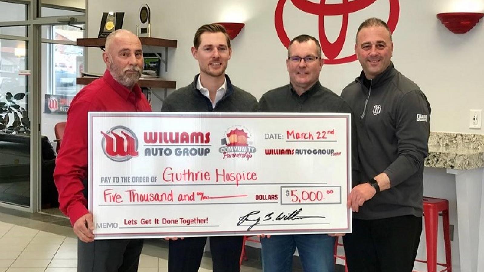 Men holding large check
