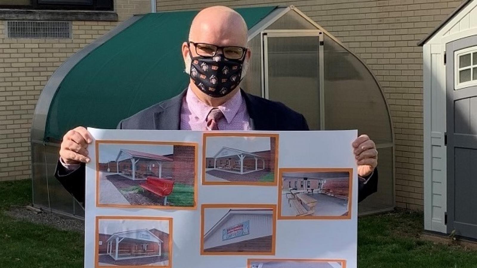 Dennis Peachey, Superintendent, Towanda Area School District, holding a rendering of the outdoor classroom.