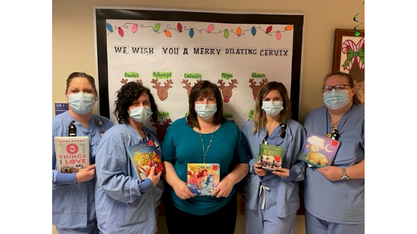Staff from the First Impressions Birthing Center at Guthrie Robert Packer Hospital pose with some of the donated books.